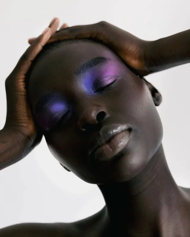 Beauty portrait with bold neon eyeshadow, photographic, editorial, dark