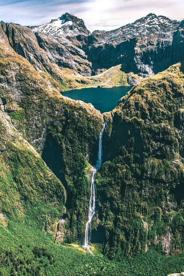 Mountain landscape with waterfall, photographic, editorial, vibrant