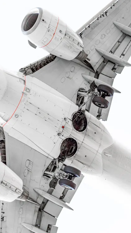 Aircraft undercarriage and engines shot from below, photographic, technical, light