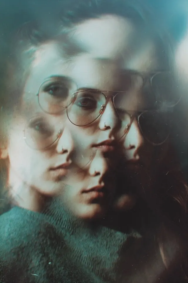 Multiple-exposure portrait with glasses and warm tones, photographic, editorial, warm