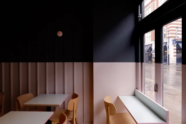 Minimalist cafe interior with wood seating and street view, minimal, architectural, warm