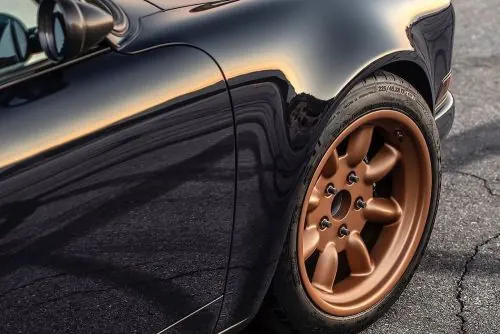 Car detail with copper wheel, photographic, warm
