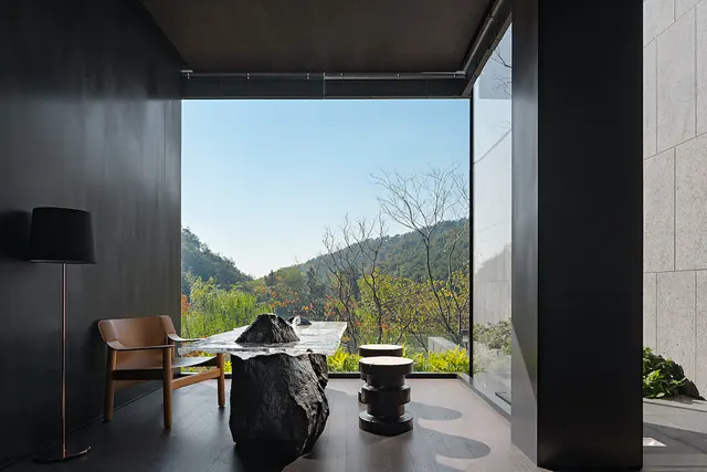 Minimalist interior with landscape view and sculptural furnishings, minimal, photographic, dark