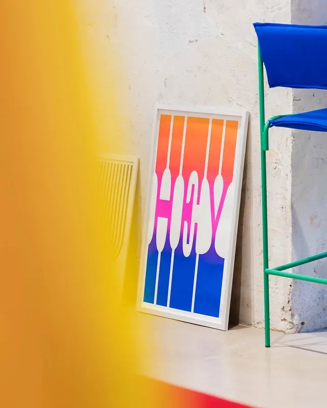 Colorful gradient poster against geometric wall installation, minimal, gradient-heavy, gradient