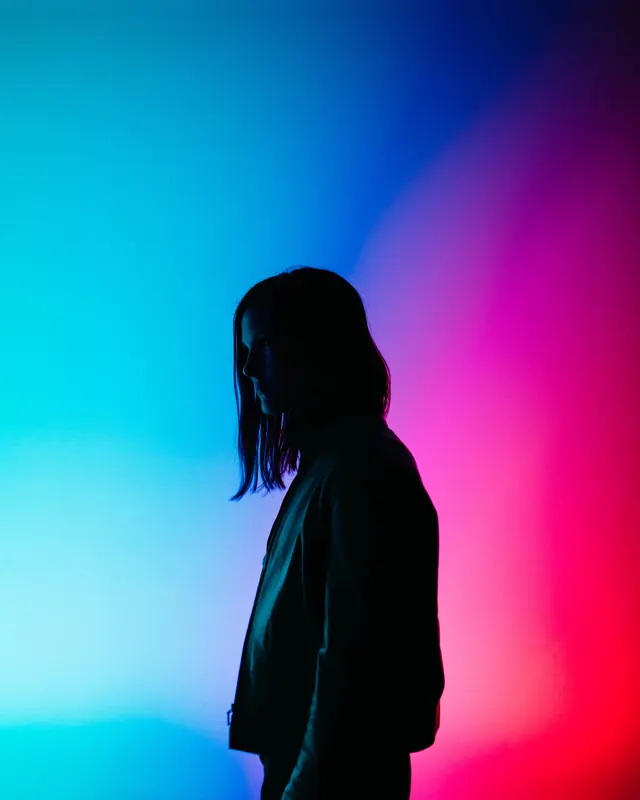Silhouette portrait with gradient background, dark-mode, gradient-heavy, vibrant