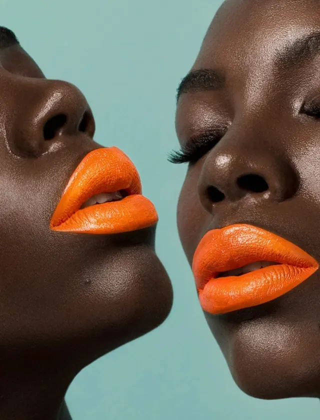 Close-up beauty portrait with vibrant orange lips, photographic, bold, vibrant