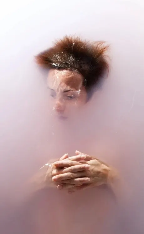 Dreamy double-exposure portrait with glitter and hands, photographic, editorial, warm