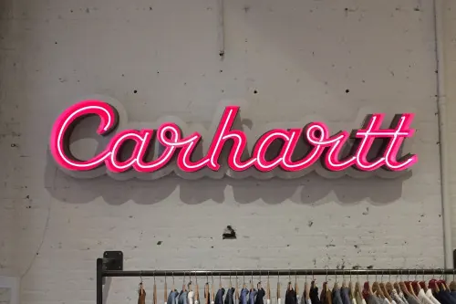 Carhartt neon sign storefront, photographic, minimal, vibrant