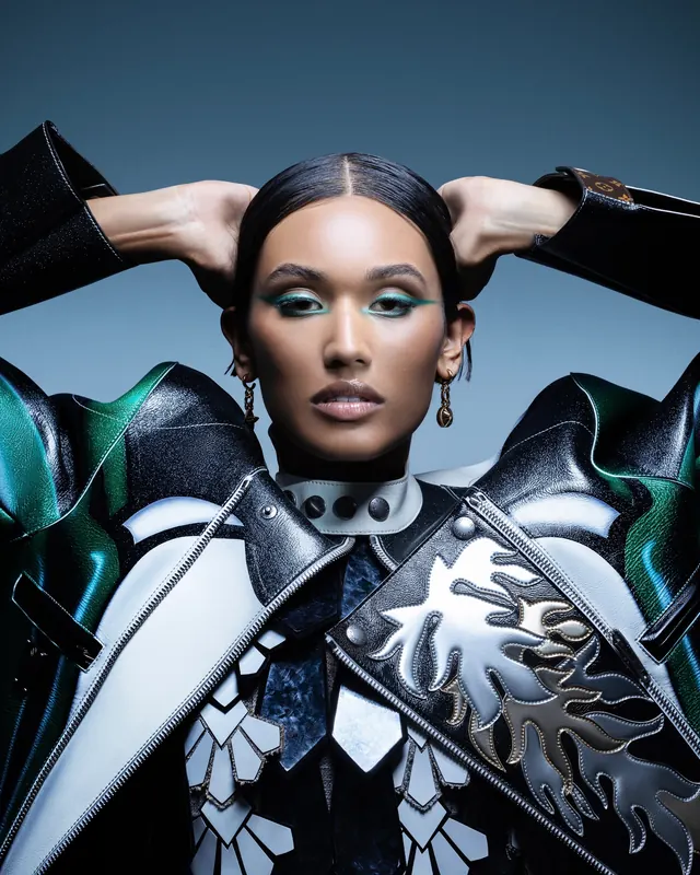 Fashion portrait with metallic sculptural shoulder accessory, photographic, editorial, vibrant