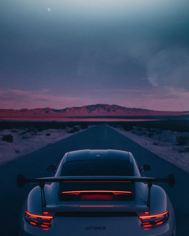 Desert road sports car at dusk, photographic, minimalist, cool