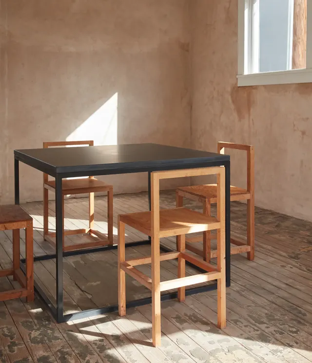 Minimalist black and wood dining table with stools, minimal, warm