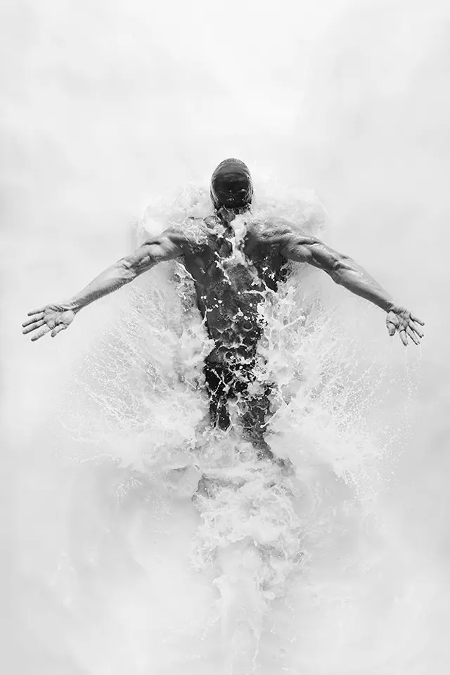 Dramatic black and white swimmer splash photograph, photographic, editorial, monochrome