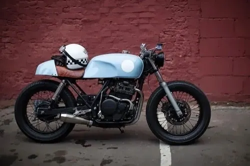Light blue cafe racer motorcycle, photographic, minimal, muted