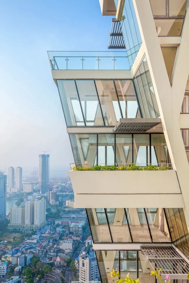 High-rise corner balconies with planters and glass facade, minimal, photographic, light