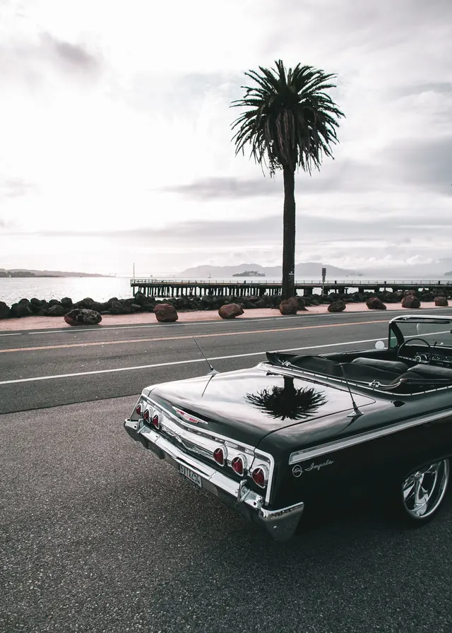 Vintage Car on Coastal Road