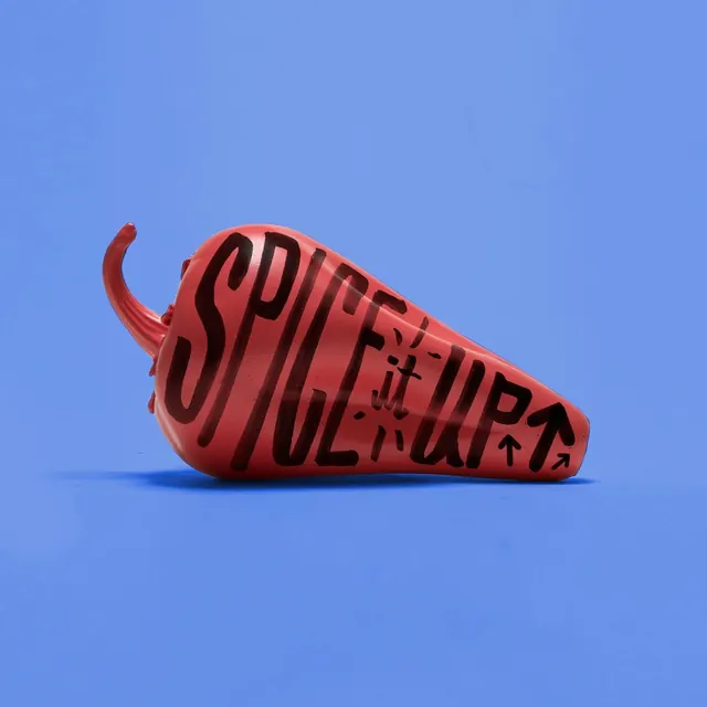 Red chili pepper prop with hand-lettered "Spice Up, photographic, playful, vibrant