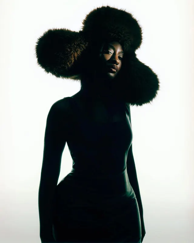 High-Contrast Portrait in Fur Headpiece