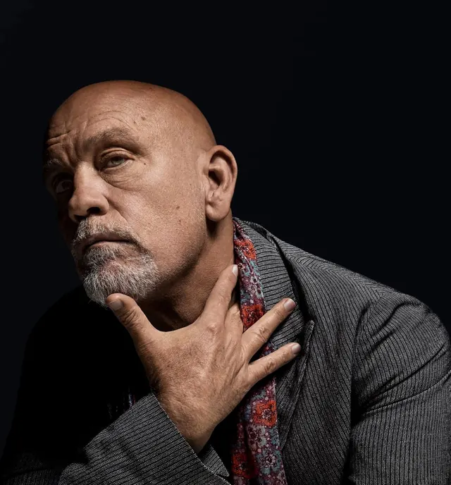 Studio portrait of bald man with gray goatee, photographic, dark