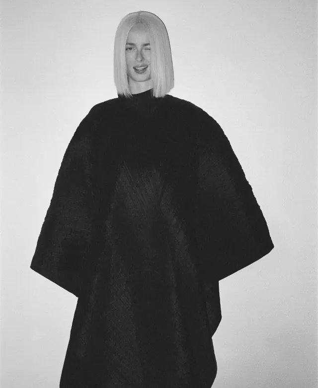 Monochrome studio portrait with oversized black poncho, minimal, monochrome, monochrome