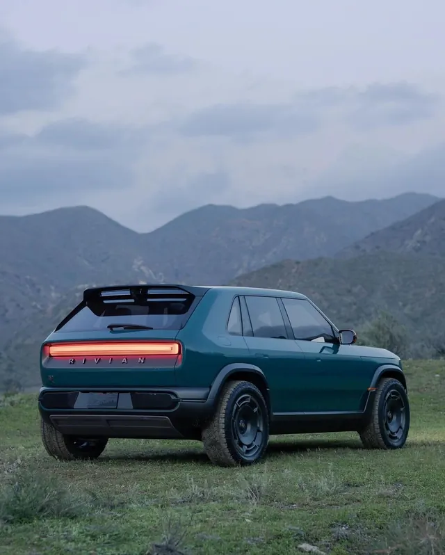 Green Vintage SUV in Mountain Landscape