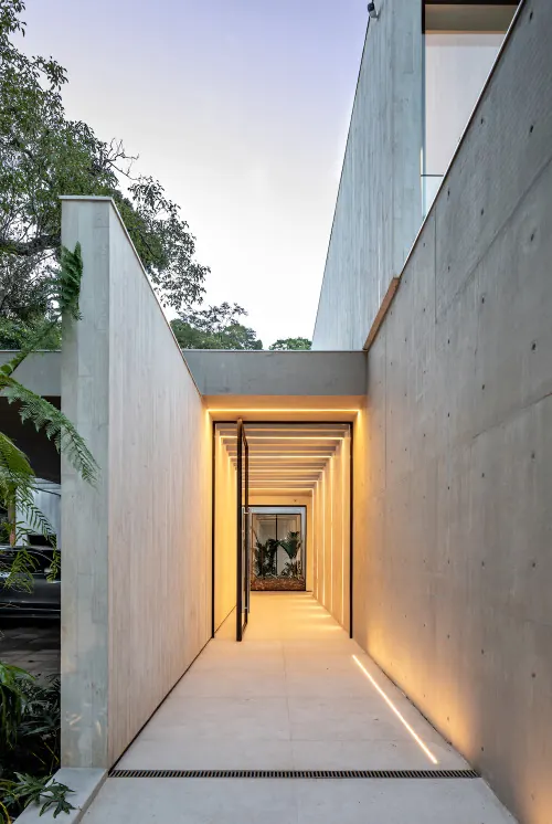 Minimalist concrete passageway with warm linear lighting, minimal, technical, muted