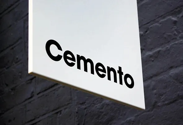 Cemento signage on brick wall, minimal, light