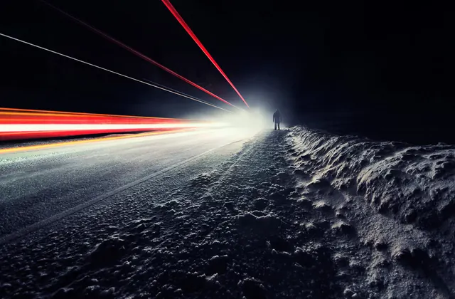 Night road with light trails and lone figure, photographic, dark-mode, dark