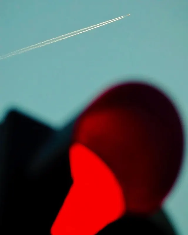 Airplane contrail and landscape blur, photographic, minimal, light