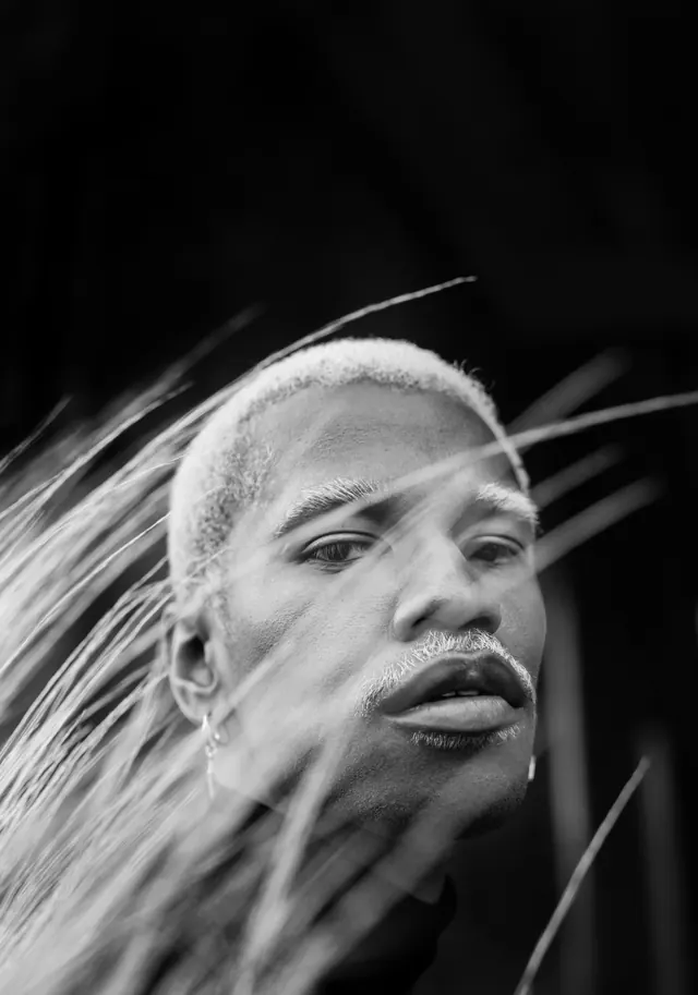 Dramatic black-and-white portrait with backlit motion, photographic, high-contrast, monochrome