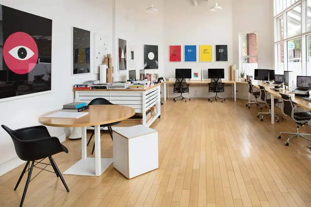Contemporary design studio workspace with colorful wall art, photographic, technical, light