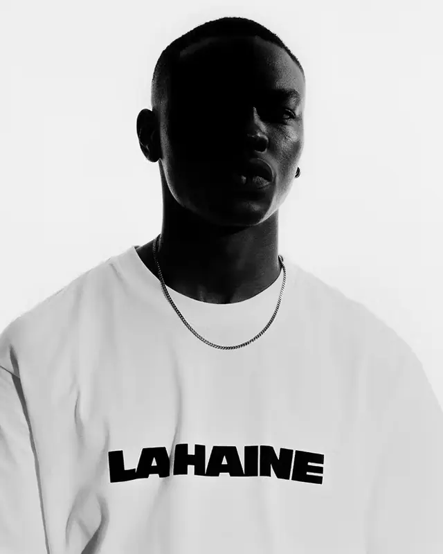 Portrait with LAHAINE text branding on white t-shirt, photographic, minimal, monochrome