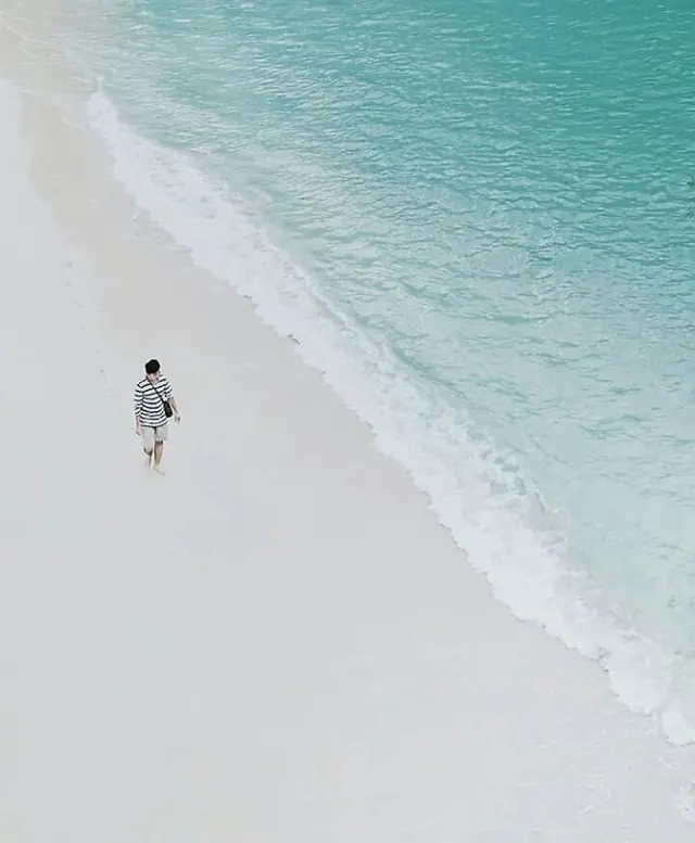 Minimal beach figure in striped shirt, photographic, minimal, cool