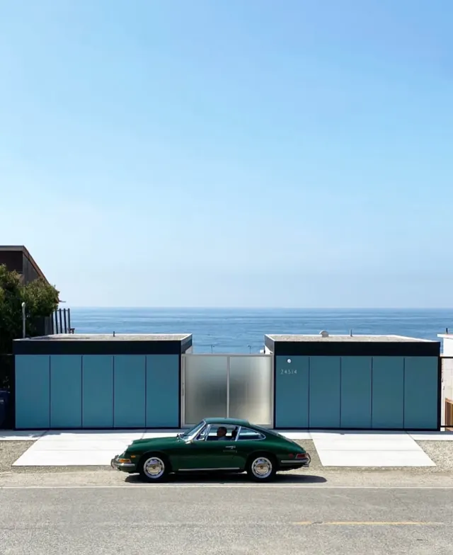 Minimalist waterfront garage with vintage car, photographic, minimal, cool