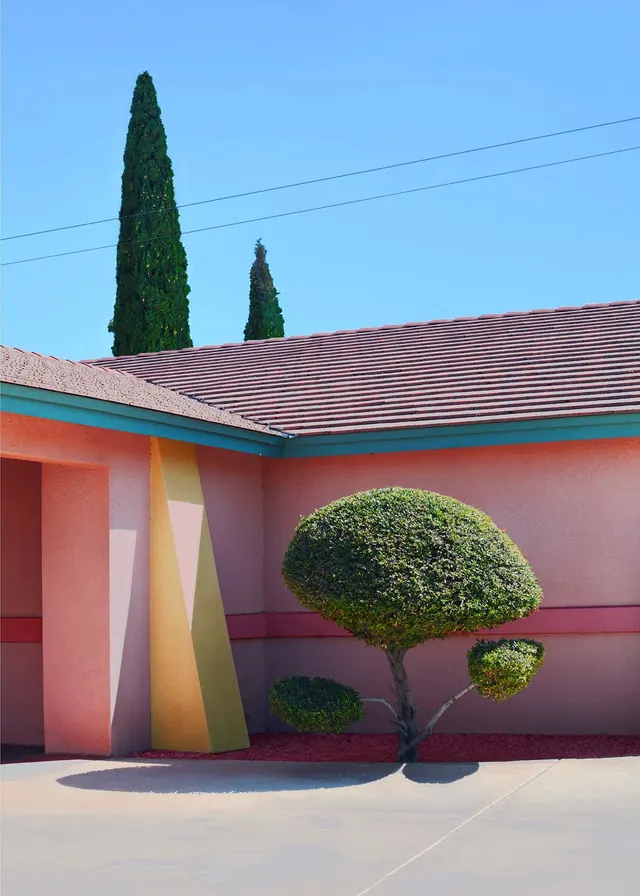 Modernist garage with neon-striped roof and topiary, minimal, photographic, warm