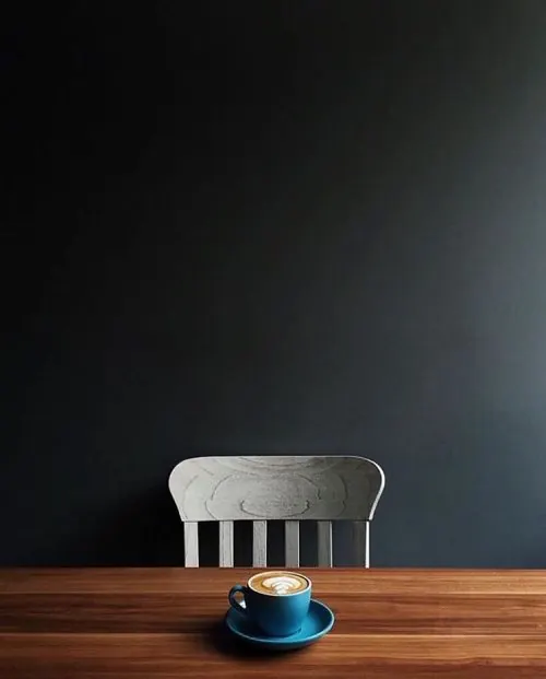 Minimalist coffee composition with chair and dark background, minimal, photographic, dark