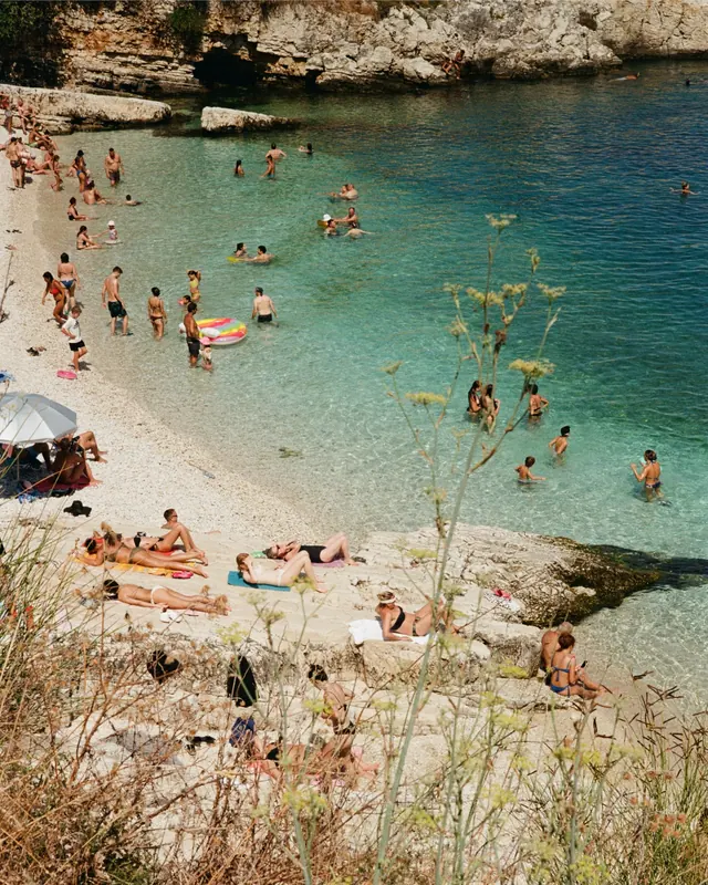 Mediterranean beach cove with swimmers, photographic, organic, cool