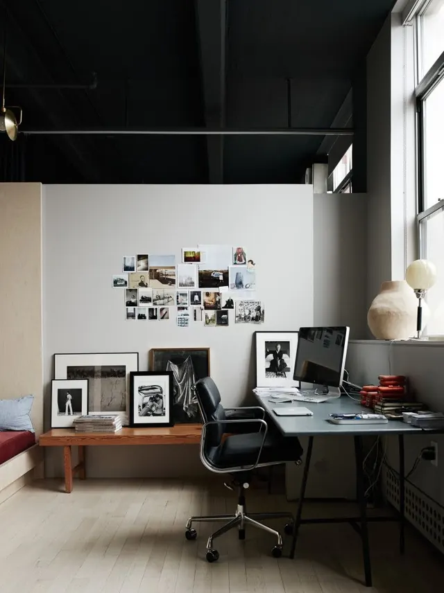 Minimalist studio workspace with gallery wall, minimal, corporate-clean, monochrome