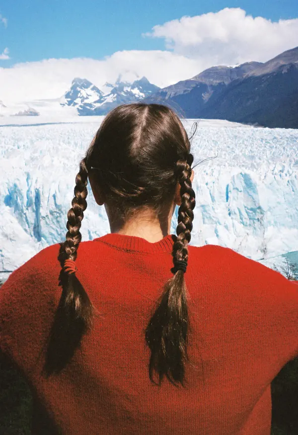 Woman in pink striped dress on glacier, photographic, minimal, vibrant