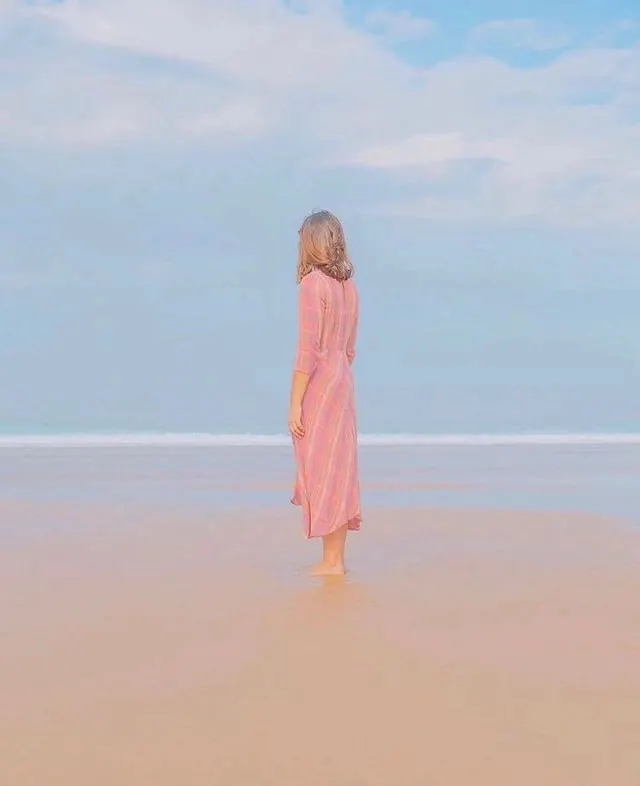 Woman in pink dress beach portrait, photographic, minimal, light