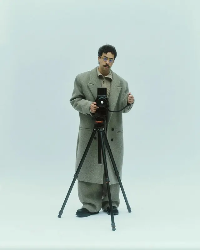 Portrait of photographer with large format camera and tripod, photographic, minimalist, pastel