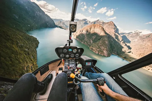 Aerial helicopter cockpit view of mountain lakes and peaks, photographic, technical, cool