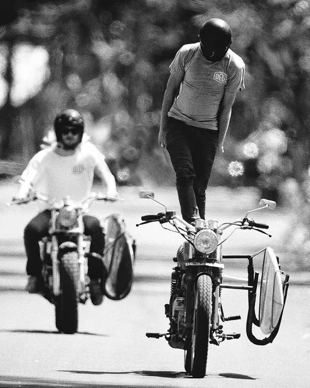 Motorcycle stunt riders in black and white action shot, photographic, editorial, monochrome