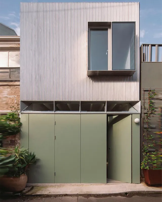 Minimalist architectural facade—corrugated metal and pastel panels, photographic, architectural, light