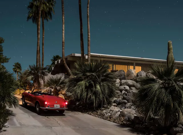 Modernist desert architecture with red vintage car at night, photographic, minimal, dark