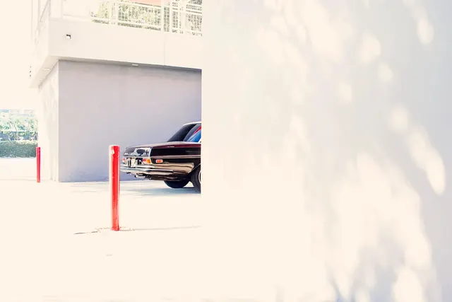 Minimalist architectural parking garage with vintage car, photographic, minimalist, light