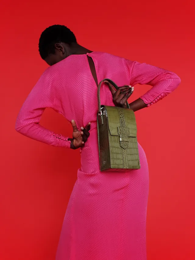 Fuchsia power suit with olive bag, photographic, editorial, vibrant