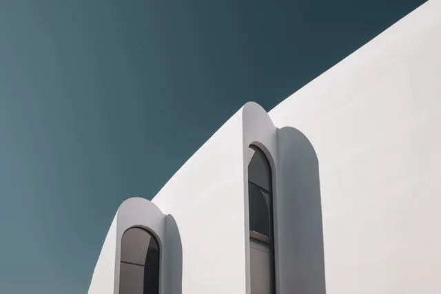 Minimalist architectural detail with arched windows, photographic, minimal, light