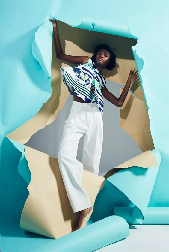 Fashion portrait with deconstructed paper geometry, photographic, editorial, cool