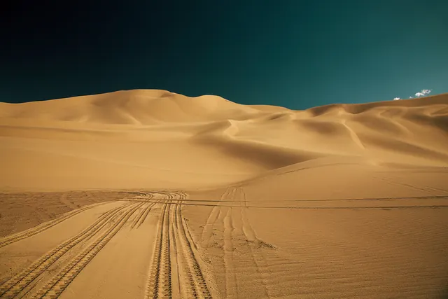 Desert dunes landscape with teal sky, photographic, minimalist, warm