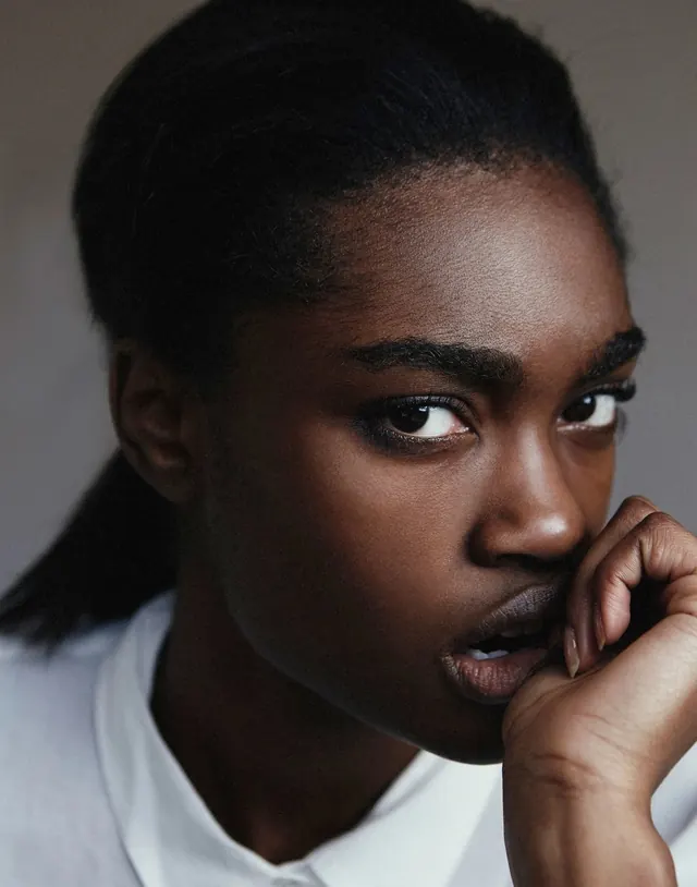 Portrait with hand on face, photographic, editorial, dark